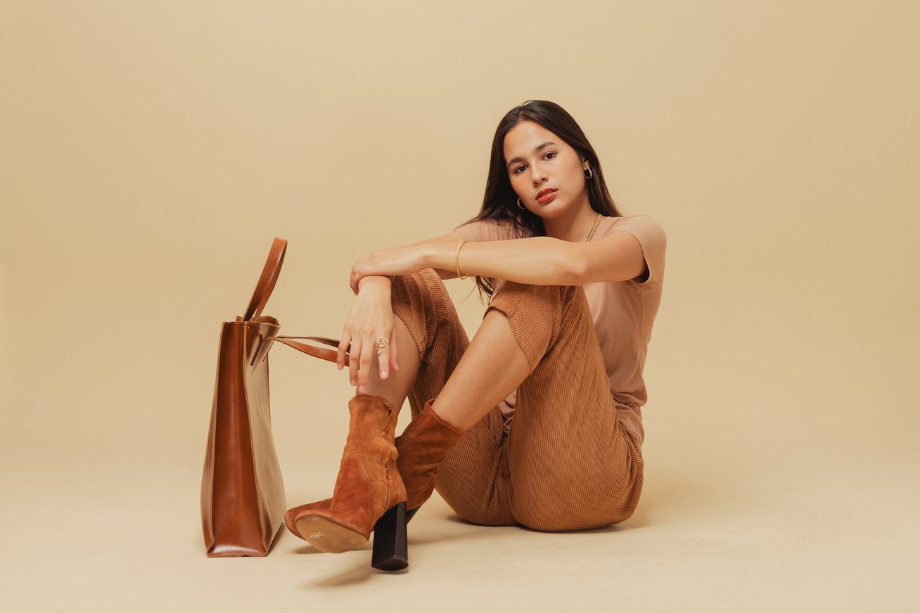 Woman in Brown Monochrome Outfit on Beige Background